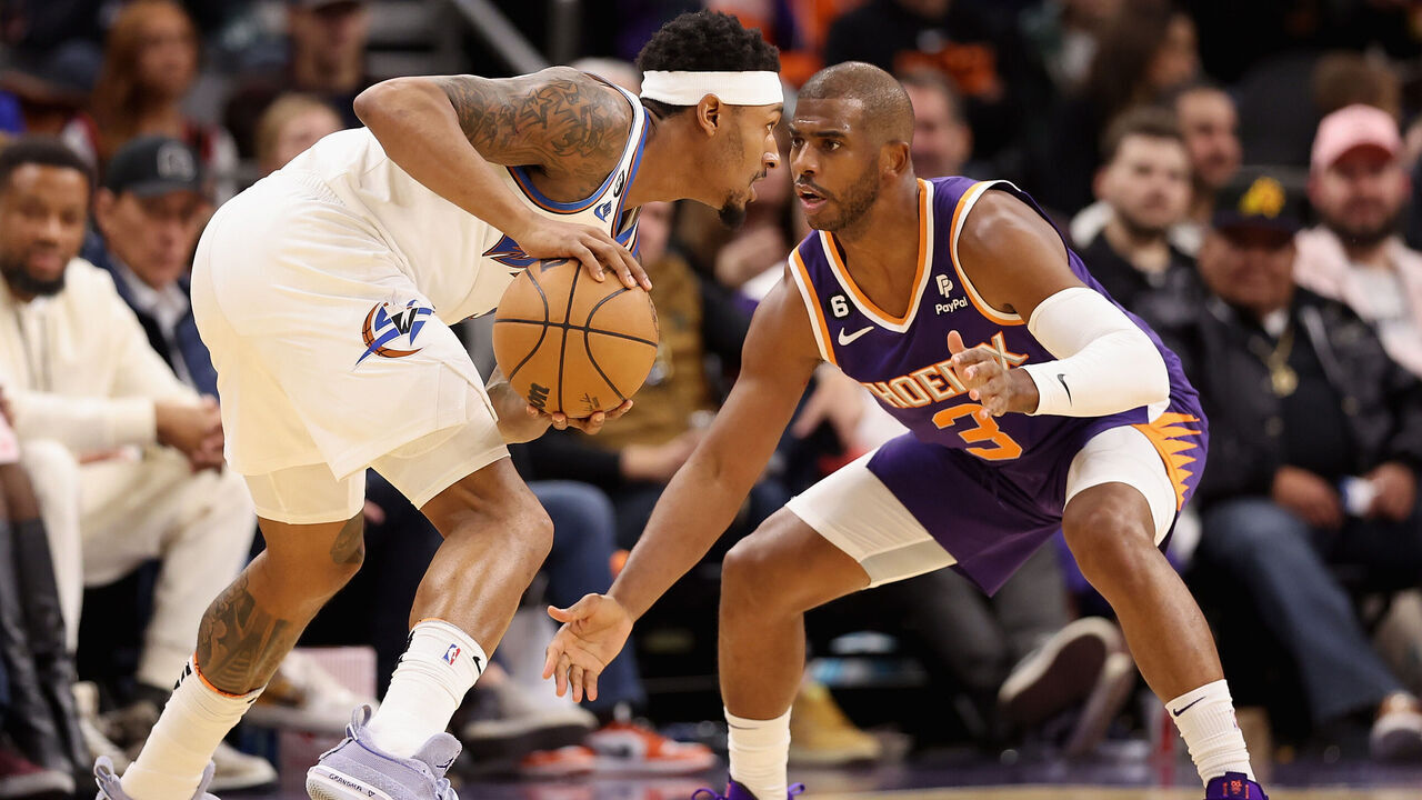 PHOENIX, ARIZONA - DECEMBER 20: Bradley Beal #3 of the Washington Wizards handles the ball against Chris Paul #3 of the Phoenix Suns during the first half of the NBA game at Footprint Center on December 20, 2022 in Phoenix, Arizona. The Wizards defeated the Suns 113-110.