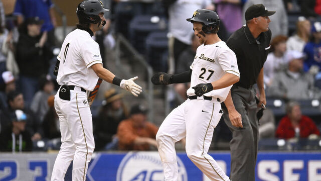 DURHAM, NORTH CAROLINA - MAY 26: Bennett Lee #27 celebrates with Lucas Costello #0 of the Wake Forest Demon Deacons after crossing home plate against the Notre Dame Fighting Irish in the second inning during the ACC Baseball Championship at Durham Bulls Athletic Park on May 26, 2023 in Durham, North Carolina.