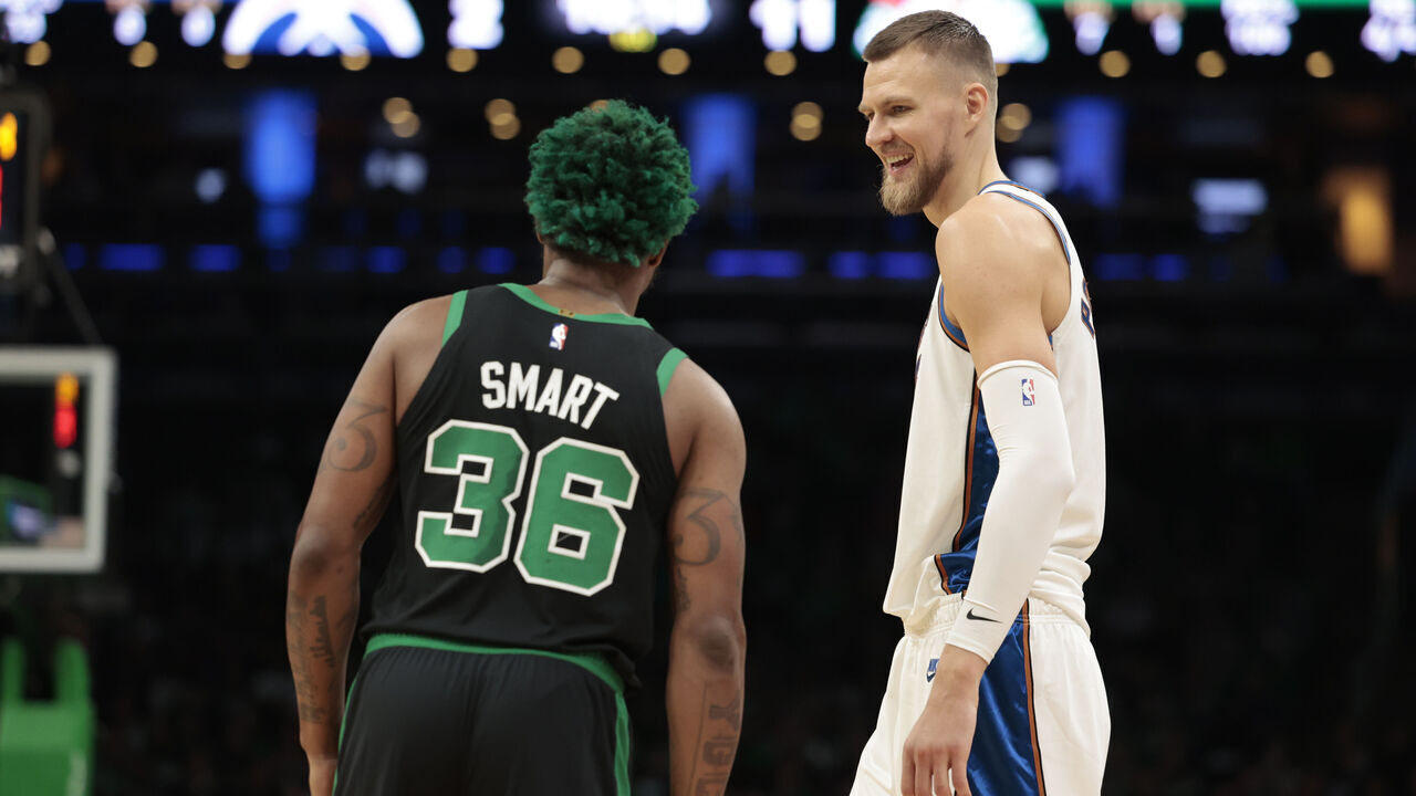 BOSTON, MASSACHUSETTS - OCTOBER 30: Kristaps Porzingis #6 of the Washington Wizards reacts with Marcus Smart #36 of the Boston Celtics during the first quarter of the game at TD Garden on October 30, 2022 in Boston, Massachusetts.