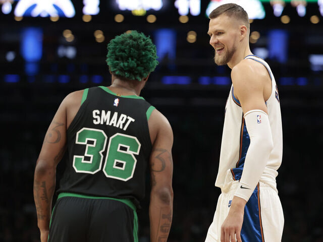 BOSTON, MASSACHUSETTS - OCTOBER 30: Kristaps Porzingis #6 of the Washington Wizards reacts with Marcus Smart #36 of the Boston Celtics during the first quarter of the game at TD Garden on October 30, 2022 in Boston, Massachusetts.
