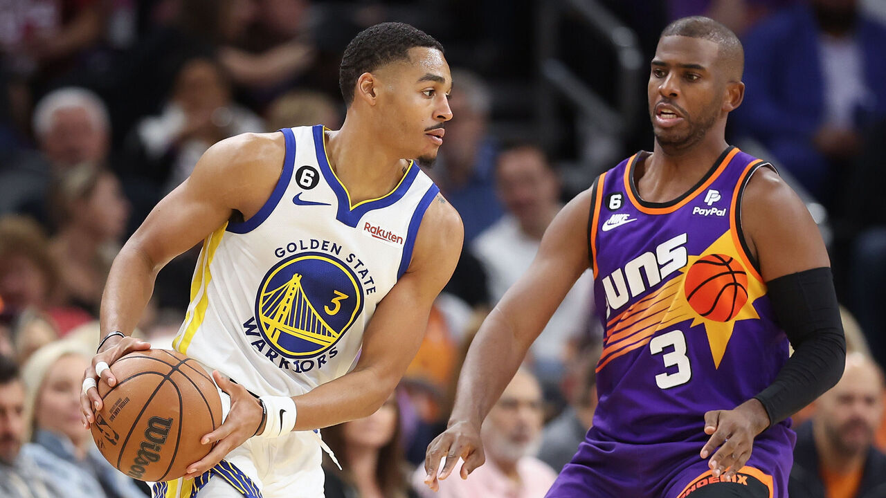PHOENIX, ARIZONA - OCTOBER 25: Jordan Poole #3 of the Golden State Warriors handles the ball against Chris Paul #3 of the Phoenix Suns during the second half of the NBA game at Footprint Center on October 25, 2022 in Phoenix, Arizona. The Suns defeated the Warriors 134-105.