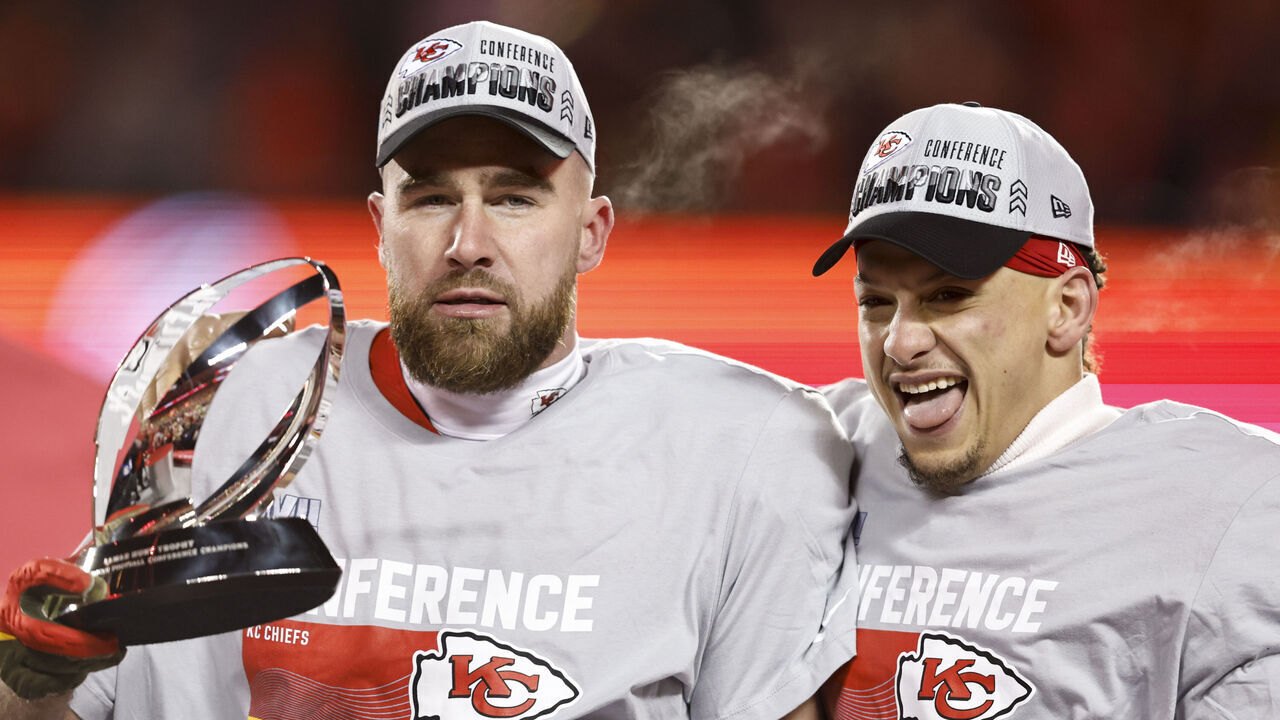 KANSAS CITY, MISSOURI - JANUARY 29: Travis Kelce #87 of the Kansas City Chiefs and Patrick Mahomes #15 of the Kansas City Chiefs celebrate with the Lamar Hunt Trophy after winning the AFC Championship NFL football game between the Kansas City Chiefs and the Cincinnati Bengals at GEHA Field at Arrowhead Stadium on January 29, 2023 in Kansas City, Missouri.