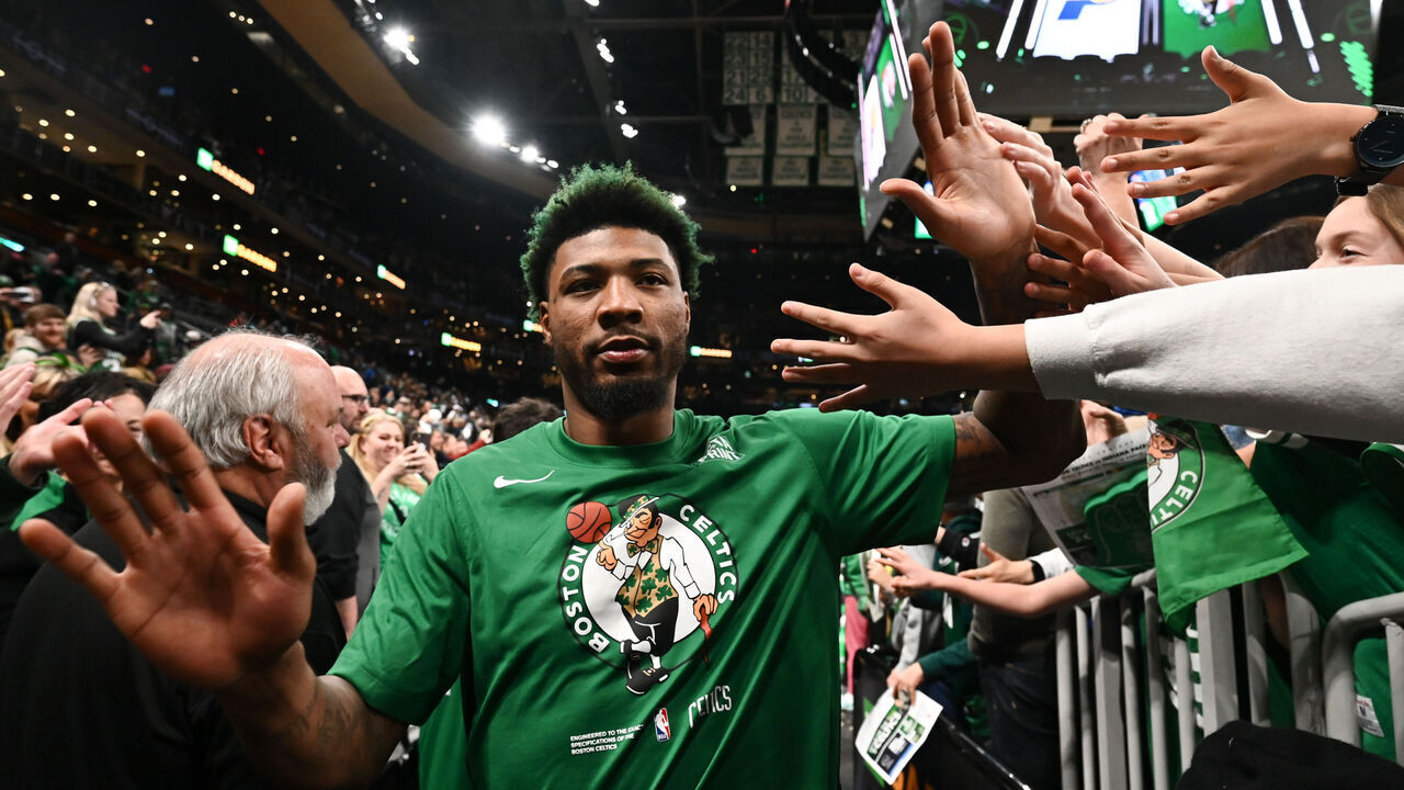BOSTON, MASSACHUSETTS - MARCH 24: Marcus Smart #36 of the Boston Celtics high fives fans after a game against the Indiana Pacers at the TD Garden on March 24, 2023 in Boston, Massachusetts.