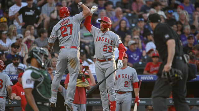 DENVER, CO - JUNE 24: Mike Trout #27 of the Los Angeles Angels celebrates with Brandon Drury #23 after hitting a third inning solo homerun in a game against the Colorado Rockies at Coors Field on June 24, 2023 in Denver, Colorado.