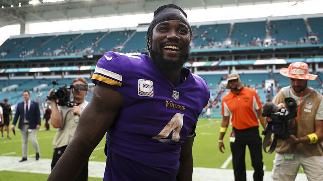 MIAMI GARDENS, FL - OCTOBER 16: Dalvin Cook #4 of the Minnesota Vikings celebrates with fans in the tunnel after an NFL football game against the Miami Dolphins at Hard Rock Stadium on October 16, 2022 in Miami Gardens, Florida.