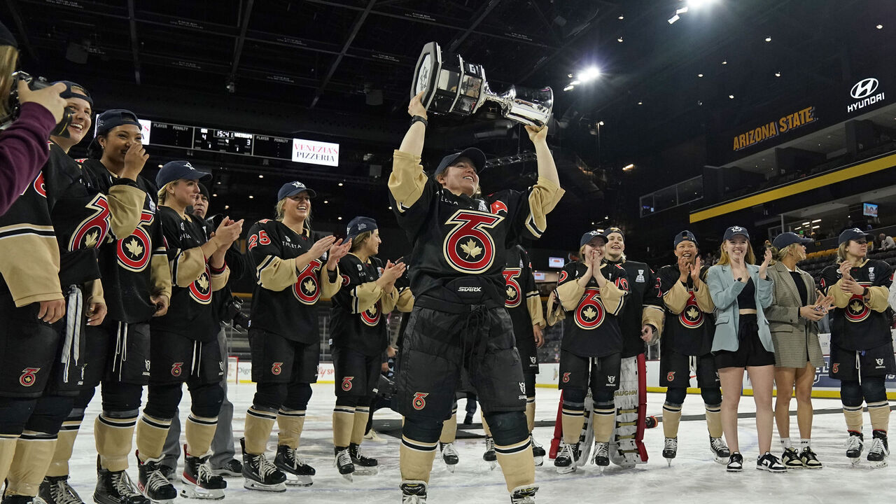TEMPE, AZ - MARCH 26: Toronto Six defense Taylor Woods (2) hoists the Isobel Cup after defeating the Minnesota Whitecaps on March 26, 2023, at Mullett Arena in Tempe, AZ.