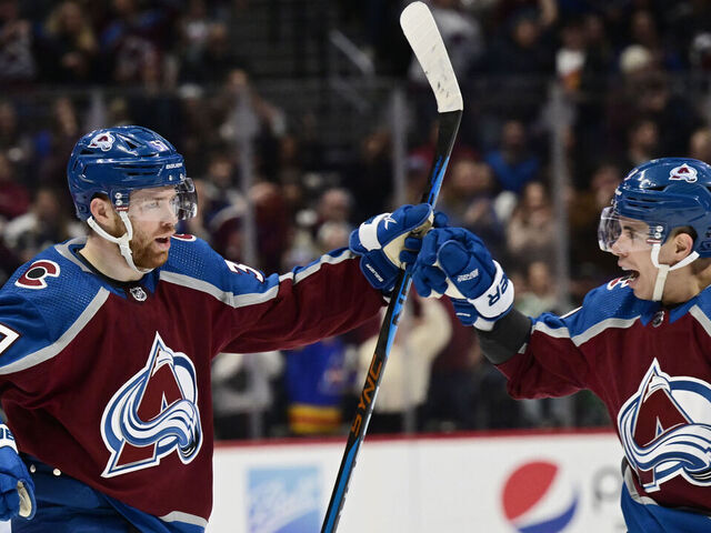 DENVER, CO - DECEMBER 31: Colorado Avalanche left wing J.T. Compher (37) and Colorado Avalanche center Evan Rodrigues (9) celebrate after Comphers goal against the Toronto Maple Leafs in the first period at Ball Arena December 31, 2022.