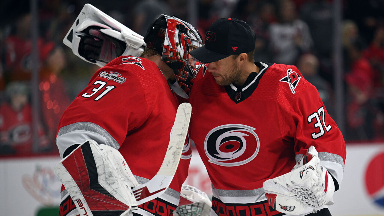 RALEIGH, NORTH CAROLINA - OCTOBER 12: Frederik Andersen and Antti Raanta #32 of the Carolina Hurricanes celebrate a victory against the Columbus Blue Jackets at PNC Arena on October 12, 2022 in Raleigh, North Carolina.
