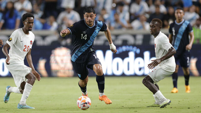 HOUSTON, TEXAS - JULY 01: Darwin Lom #14 of Guatemala controls the ball ahead of Ali Ahmed #20 of Canada during the first half of the Concacaf Gold Cup match at Shell Energy Stadium on July 01, 2023 in Houston, Texas.