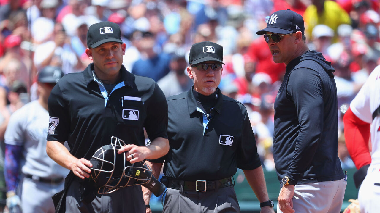 ST LOUIS, MISSOURI - JULY 2: Manager Aaron Boone #17 of the New York Yankees yells to home plate umpire Dan Merzel #107 as umpire Lance Barksdale #23 intervenes during a game against the St. Louis Cardinals in the third inning at Busch Stadium on July 2, 2023 in St Louis, Missouri.