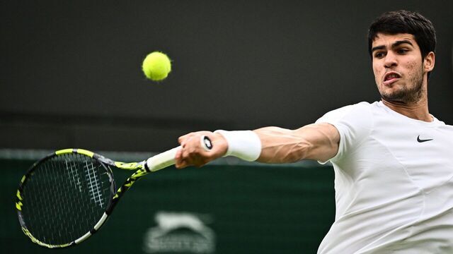 Spain's Carlos Alcaraz returns the ball to France's Jeremy Chardy during their men's singles tennis match on the second day of the 2023 Wimbledon Championships at The All England Tennis Club in Wimbledon, southwest London, on July 4, 2023.