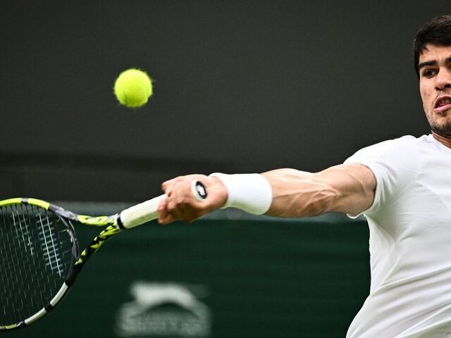 Spain's Carlos Alcaraz returns the ball to France's Jeremy Chardy during their men's singles tennis match on the second day of the 2023 Wimbledon Championships at The All England Tennis Club in Wimbledon, southwest London, on July 4, 2023.