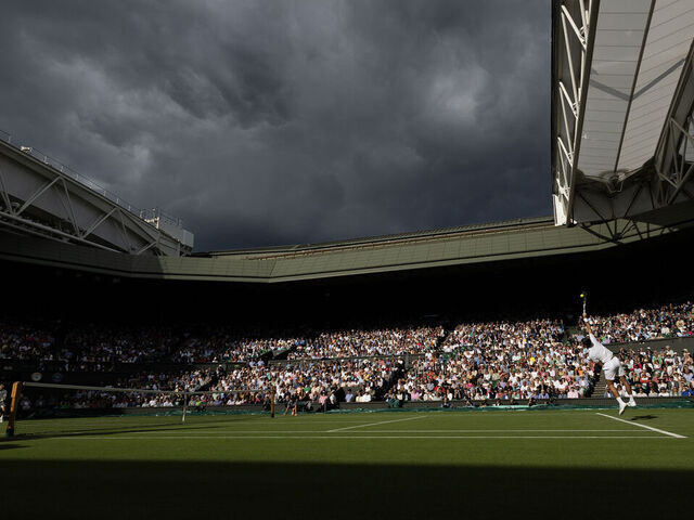 LONDON, ENGLAND - JULY 5. A brief moment of sunshine lights up Centre Court and the gathering clouds on a rain-interrupted day as Novak Djokovic of Serbia plays against Jordan Thompson of Australia in the Gentlemens Singles second-round match on Centre Court during the Wimbledon Lawn Tennis Championships at the All England Lawn Tennis and Croquet Club at Wimbledon on July 05, 2023, in London, England.