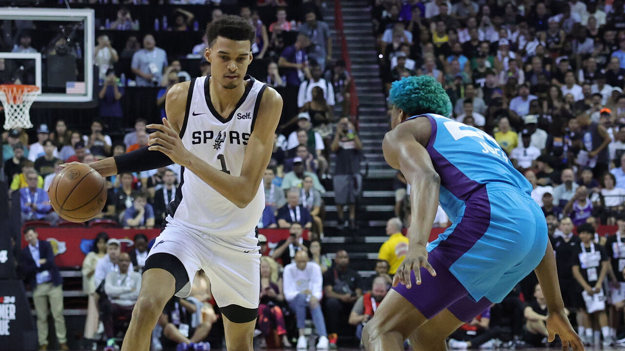 LAS VEGAS, NEVADA - JULY 07: Victor Wembanyama #1 of the San Antonio Spurs dribbles the ball against Kai Jones #23 of the Charlotte Hornets during the first quarter at the Thomas & Mack Center on July 07, 2023 in Las Vegas, Nevada.