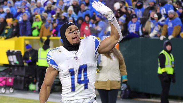 GREEN BAY, WISCONSIN - JANUARY 08: Amon-Ra St. Brown #14 of the Detroit Lions greets fans after defeating the Green Bay Packers at Lambeau Field on January 08, 2023 in Green Bay, Wisconsin.