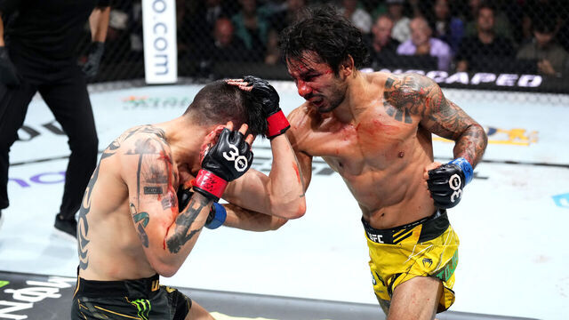 LAS VEGAS, NEVADA - JULY 08: (R-L) Alexandre Pantoja of Brazil punches Brandon Moreno of Mexico in the UFC flyweight championship fight during the UFC 290 event at T-Mobile Arena on July 08, 2023 in Las Vegas, Nevada.