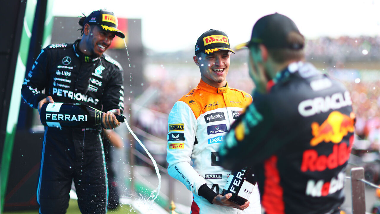NORTHAMPTON, ENGLAND - JULY 09: Race winner, Max Verstappen of the Netherlands and Oracle Red Bull Racing, Second placed Lando Norris of Great Britain and McLaren celebrates with third placed Lewis Hamilton of Great Britain and Mercedes on the podium during the F1 Grand Prix of Great Britain at Silverstone Circuit on July 09, 2023 in Northampton, England.