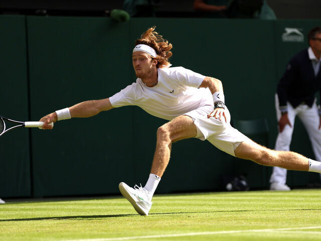 LONDON, ENGLAND - JULY 09: Andrey Rublev stretches to play a forehand against Alexander Bublik of Kazakhstan in the Men's Singles fourth round match during day seven of The Championships Wimbledon 2023 at All England Lawn Tennis and Croquet Club on July 09, 2023 in London, England.