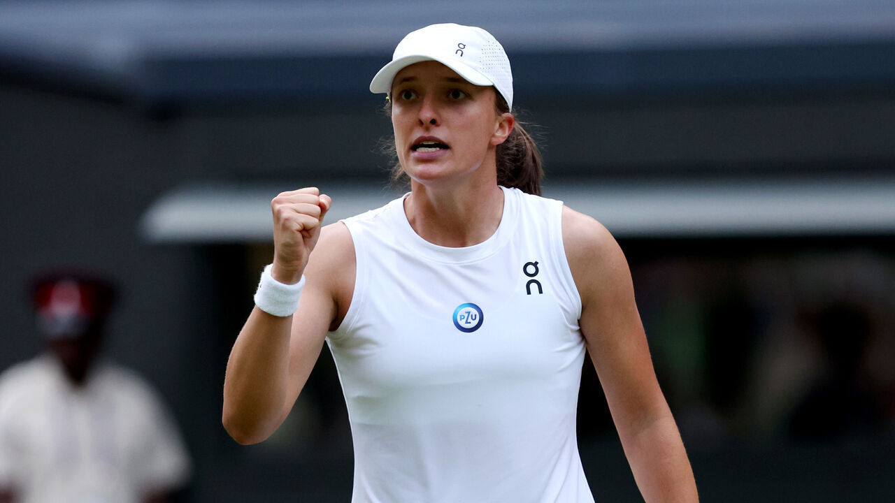 LONDON, ENGLAND - JULY 09: Iga Swiatek of Poland celebrates winning match point against Belinda Bencic of Switzerland in the Women's Singles fourth round match during day seven of The Championships Wimbledon 2023 at All England Lawn Tennis and Croquet Club on July 09, 2023 in London, England.