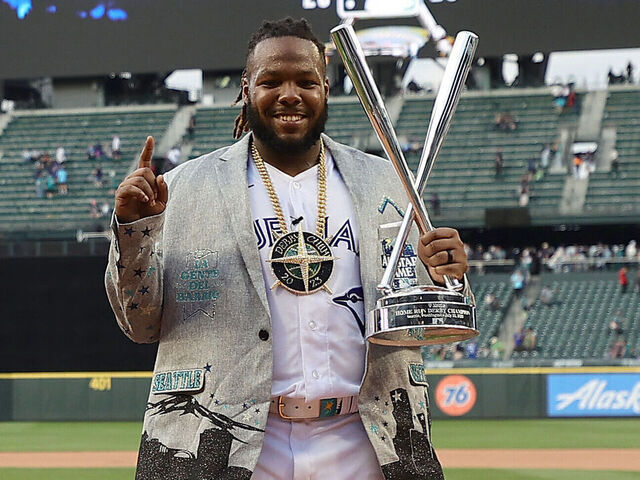 SEATTLE, WASHINGTON - JULY 10: Vladimir Guerrero Jr. #27 of the Toronto Blue Jays poses for photos with his trophy after winning the T-Mobile Home Run Derby at T-Mobile Park on July 10, 2023 in Seattle, Washington.