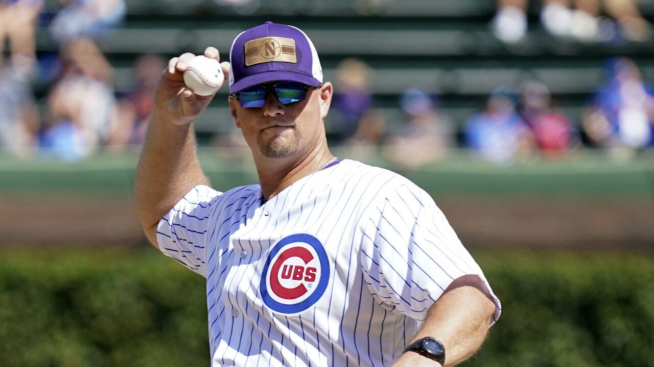 CHICAGO, ILLINOIS - SEPTEMBER 18: Northwestern baseball head coach Jim Foster throws the ceremonial first pitch of the game between the Chicago Cubs and the Colorado Rockies at Wrigley Field on September 18, 2022 in Chicago, Illinois.