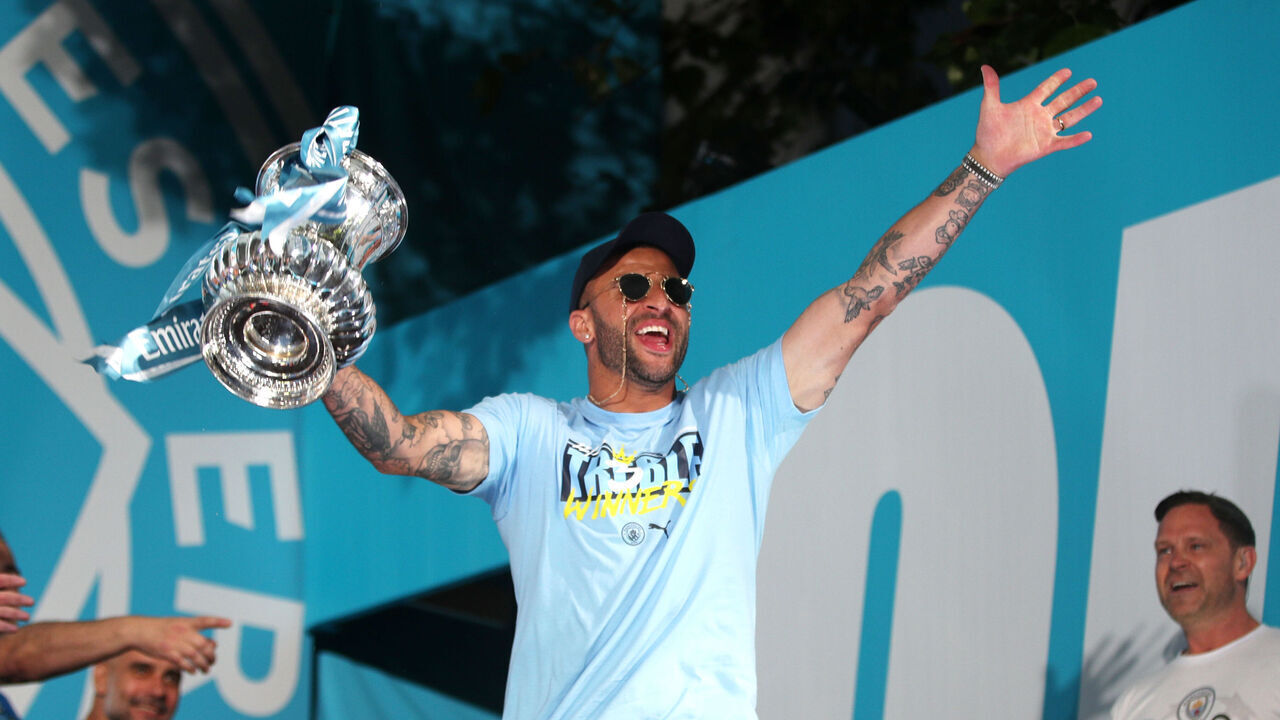 MANCHESTER, ENGLAND - JUNE 12: Kyle Walker of Manchester City celebrates with the FA Cup Trophy on stage in St Peter's Square during the Manchester City trophy parade on June 12, 2023 in Manchester, England.