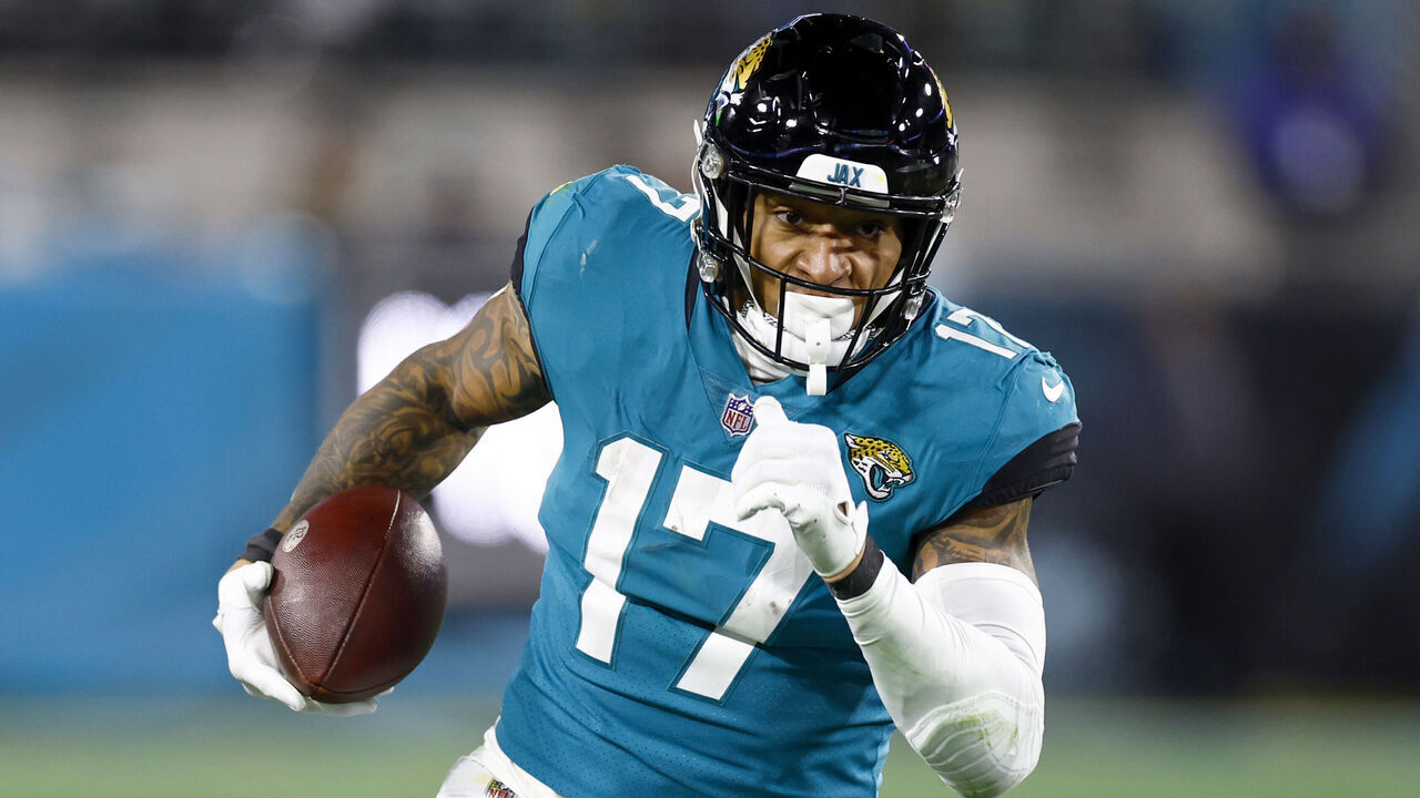 JACKSONVILLE, FLORIDA - JANUARY 14: Evan Engram #17 of the Jacksonville Jaguars carries the ball against the Los Angeles Chargers during the second half of the game in the AFC Wild Card playoff game at TIAA Bank Field on January 14, 2023 in Jacksonville, Florida.