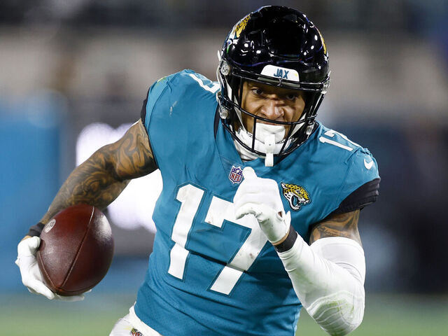 JACKSONVILLE, FLORIDA - JANUARY 14: Evan Engram #17 of the Jacksonville Jaguars carries the ball against the Los Angeles Chargers during the second half of the game in the AFC Wild Card playoff game at TIAA Bank Field on January 14, 2023 in Jacksonville, Florida.