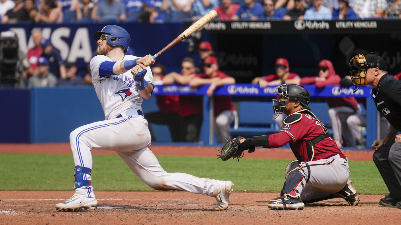 TORONTO, ON - JULY 16: Danny Jansen #9 of the Toronto Blue Jays hits a three-RBI double during the eighth inning against the Arizona Diamondbacks at the Rogers Centre on July 16, 2023 in Toronto, Canada.