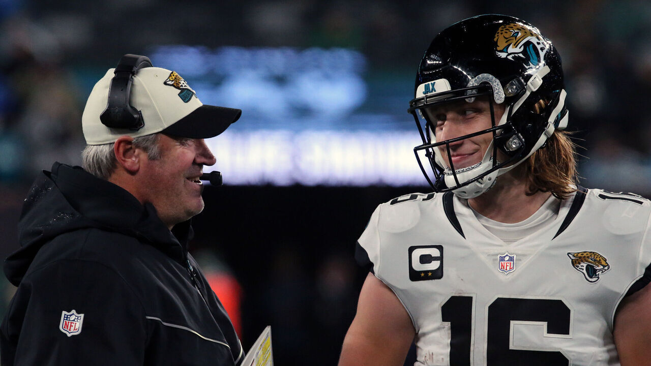 EAST RUTHERFORD, NEW JERSEY - DECEMBER 22: Head Coach Doug Pederson discusses a play with Quarterback Trevor Lawrence #16 of the Jacksonville Jaguars in the Thursday Night Football game in the rain between the Jacksonville Jaguars vs the New York Jets at MetLife Stadium on December 22, 2022 in East Rutherford, New Jersey.