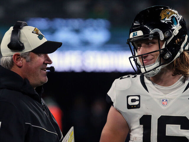 EAST RUTHERFORD, NEW JERSEY - DECEMBER 22: Head Coach Doug Pederson discusses a play with Quarterback Trevor Lawrence #16 of the Jacksonville Jaguars in the Thursday Night Football game in the rain between the Jacksonville Jaguars vs the New York Jets at MetLife Stadium on December 22, 2022 in East Rutherford, New Jersey.