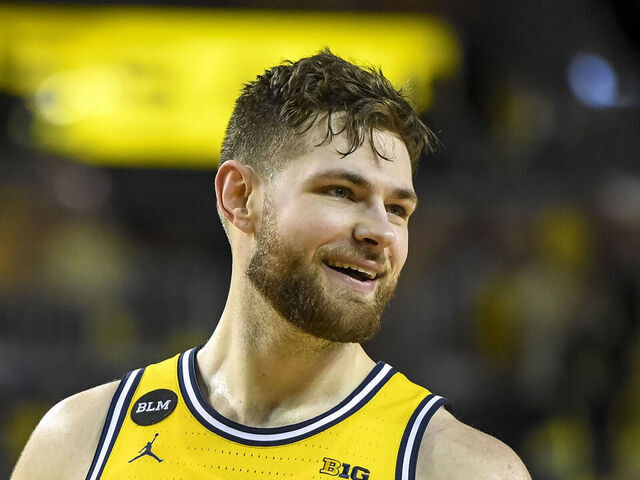 ANN ARBOR, MICHIGAN - MARCH 01: Hunter Dickinson #1 of the Michigan Wolverines looks on and smiles against the Michigan State Spartans during the second half at Crisler Arena on March 01, 2022 in Ann Arbor, Michigan.