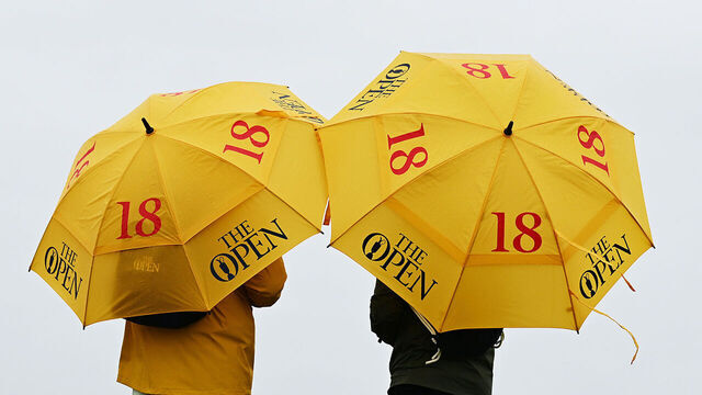 HOYLAKE, ENGLAND - JULY 18: A view of spectators looking on with official "The Open" umbrellas during a practice round prior to The 151st Open at Royal Liverpool Golf Club on July 18, 2023 in Hoylake, England.