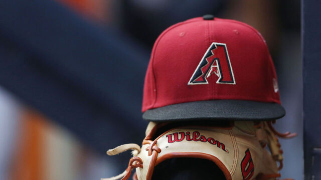 MILWAUKEE, WI - OCTOBER 05: An Arizona Diamondbacks hat and glove sit on the wall during a game between the Milwaukee Brewers and the Arizona Diamondbacks on October 5, 2022, at American Family Field, in Milwaukee, WI.