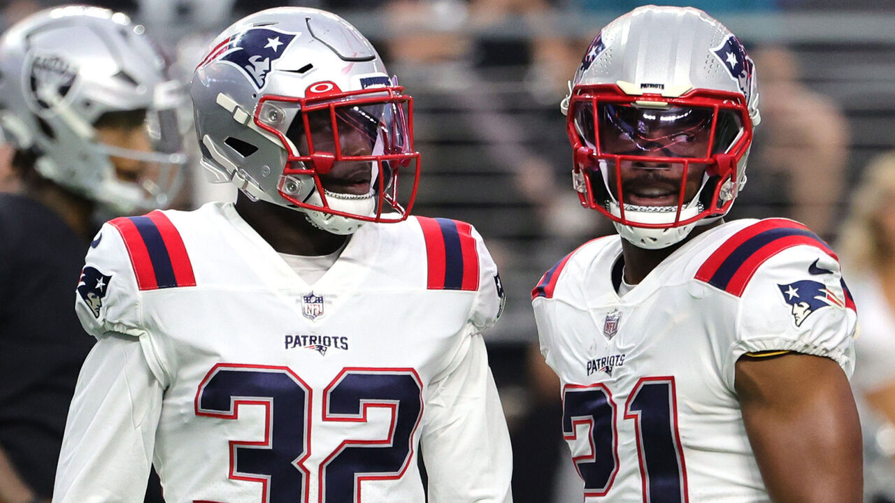 LAS VEGAS, NEVADA - AUGUST 26: Safeties Devin McCourty #32 and Adrian Phillips #21 of the New England Patriots stand on the field between plays against the Las Vegas Raiders during their preseason game at Allegiant Stadium on August 26, 2022 in Las Vegas, Nevada. The Raiders defeated the Patriots 23-6.