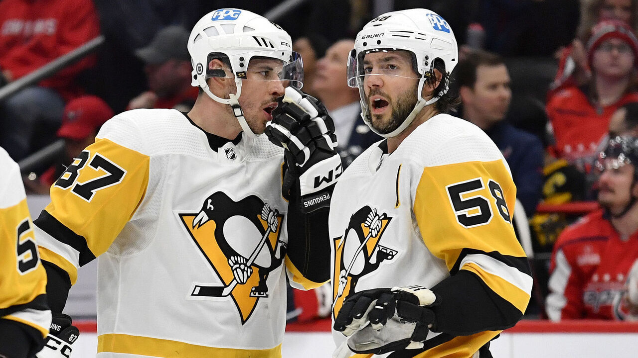 WASHINGTON, DC - JANUARY 26: Penguins center Sidney Crosby (87) talks with defenseman Kris Letang (58) before a face-off during the Pittsburgh Penguins versus Washington Capitals National Hockey League game on January 26, 2023 at Capital One Arena in Washington, D.C..