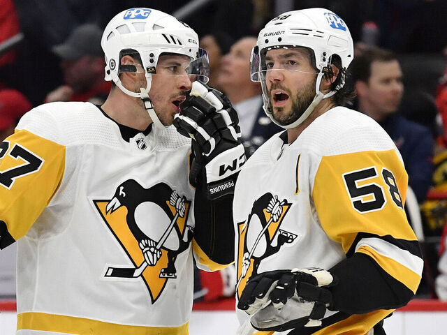 WASHINGTON, DC - JANUARY 26: Penguins center Sidney Crosby (87) talks with defenseman Kris Letang (58) before a face-off during the Pittsburgh Penguins versus Washington Capitals National Hockey League game on January 26, 2023 at Capital One Arena in Washington, D.C..