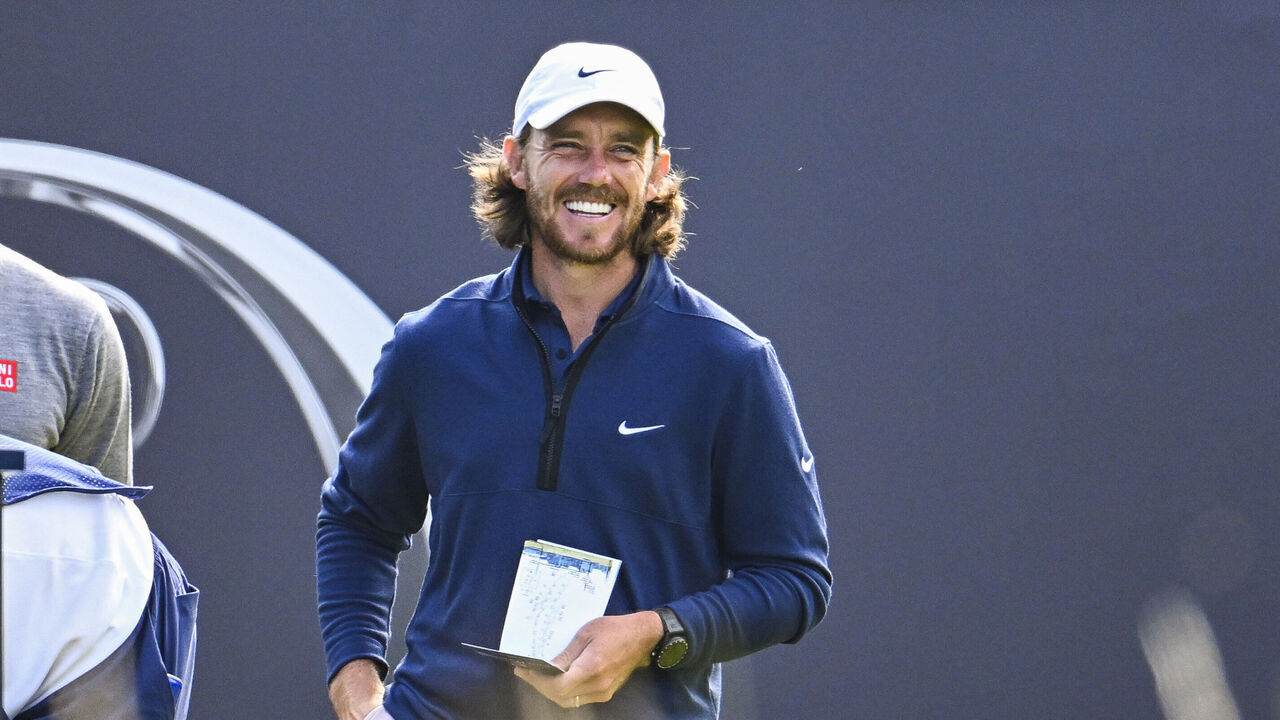 HOYLAKE, ENGLAND - JULY 20: Tommy Fleetwood of England smiles with Adam Scott of Australia on the first tee during the first round of The 151st Open Championship at Royal Liverpool Golf Club on July 20, 2023 in Hoylake, England.