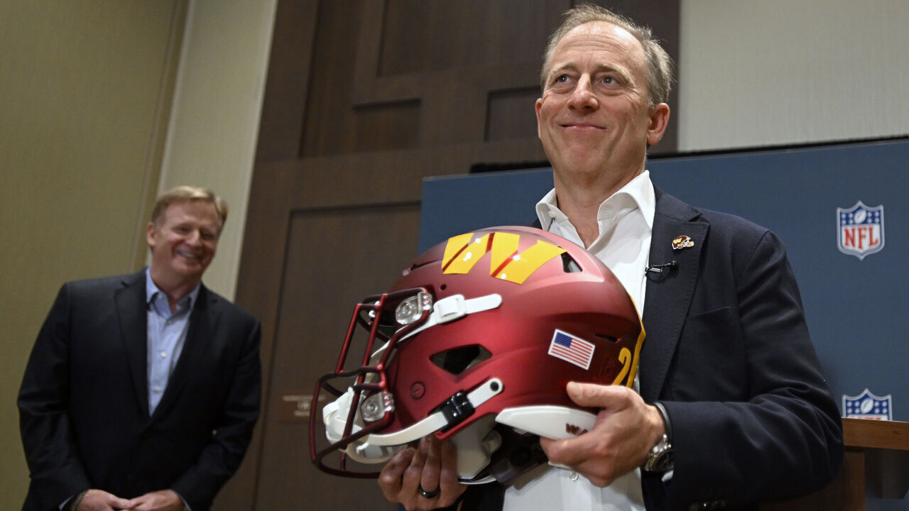 BLOOMINGTON , MN - JULY 20: NFL Commissioner Roger Goodell, left, looks on after presenting Washington Commanders controlling owner Josh Harris with his new team's helmet after the NFL owners voted to approve the purchase of the team to Harris's group in special meeting at the JW Marriott Hotel on July 20, 2023 in Bloomington , MN.