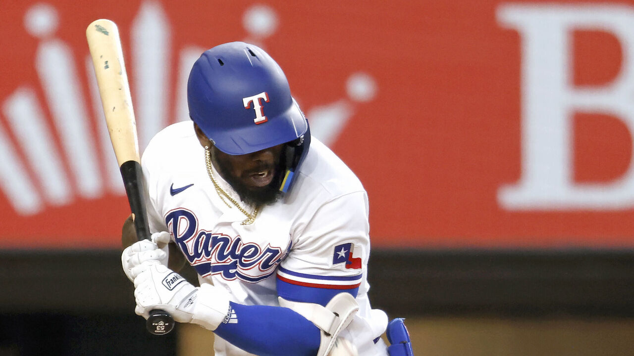 Rangers slugger Adolis García, leading the AL in RBIs, exits game after  getting hit by a pitch