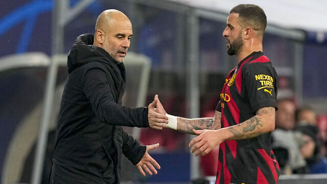 LEIPZIG, GERMANY - FEBRUARY 22: head coach Pep Guardiola of Manchester City shake hands with Kyle Walker of Manchester City during the UEFA Champions League round of 16 leg one match between RB Leipzig and Manchester City at Red Bull Arena on February 22, 2023 in Leipzig, Germany.