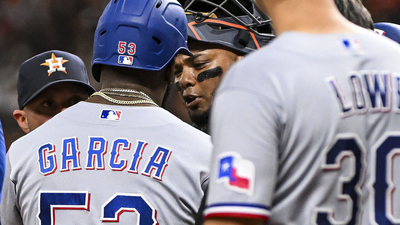 HOUSTON, TEXAS - JULY 26: Adolis Garcia #53 of the Texas Rangers exchanges words with catcher Martin Maldonado #15 of the Houston Astros after Garcia's grand slam in the fifth inning at Minute Maid Park on July 26, 2023 in Houston, Texas.