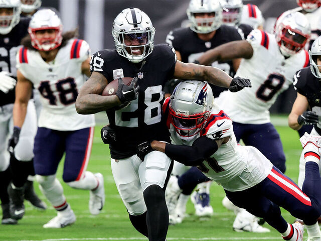 LAS VEGAS, NEVADA - DECEMBER 18: Josh Jacobs #28 of the Las Vegas Raiders carries the ball against the New England Patriots during the first quarter of the game at Allegiant Stadium on December 18, 2022 in Las Vegas, Nevada.