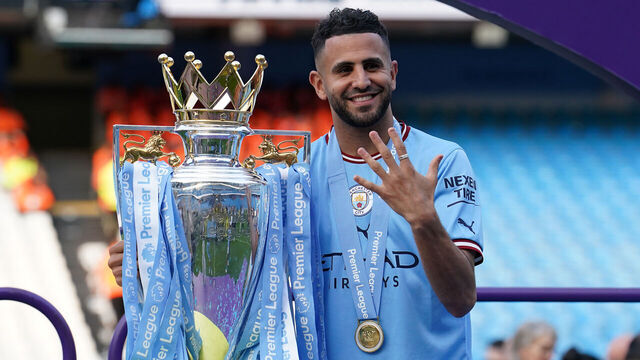 Manchester City's Riyad Mahrez celebrates with the Premier League trophy following the Premier League match at the Etihad Stadium, Manchester. Picture date: Sunday May 21, 2023.