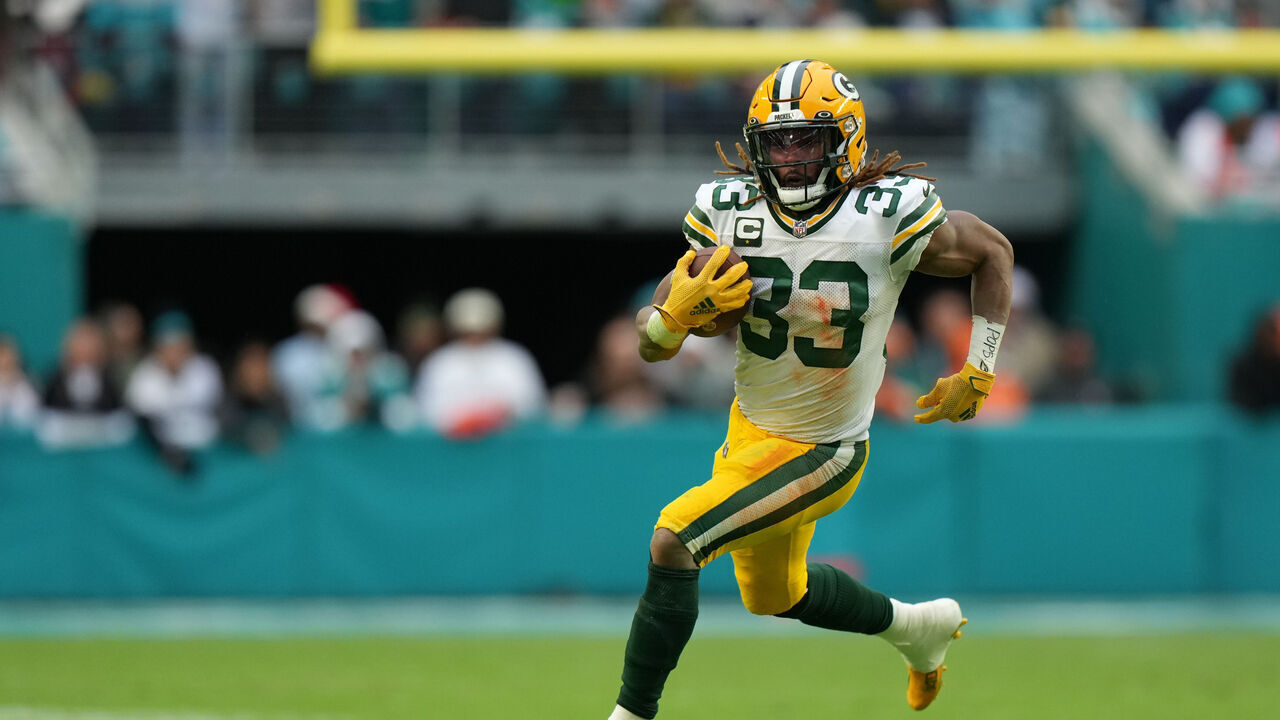 MIAMI GARDENS, FL - DECEMBER 25: Green Bay Packers running back Aaron Jones (33) runs for a first down in the second half during the game between the Green Bay Packers and the Miami Dolphins on Sunday, December 25, 2022 at Hard Rock Stadium, Miami Gardens, Fla.