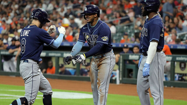 HOUSTON, TEXAS - JULY 28: Brandon Lowe (L) #8 of the Tampa Bay Rays is welcomed at home plate by teammates Wander Franco (C) #5 and Randy Arozarena #56 after hitting a home run in the first inning against the Houston Astros at Minute Maid Park on July 28, 2023 in Houston, Texas.