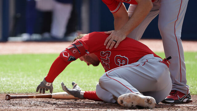 TORONTO, ON - JULY 29 - Los Angeles Angels third base coach Bill Haselman (82) checks on Los Angeles Angels left fielder Taylor Ward (3) after he is hit by a pitch as the Toronto Blue Jays play the Los Angeles Angels at Rogers Centre in Toronto. July 29, 2023. (Steve Russell/Toronto Star via Getty Images)