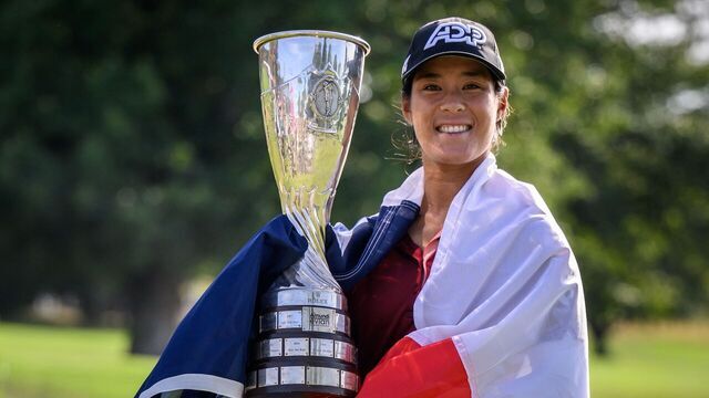 France's Celine Boutier, wrapped in a French flag, poses with her trophy after winning the Evian Championship, a women's LPGA major golf tournament in Evian-les-Bains, French Alps, on July 30, 2023.