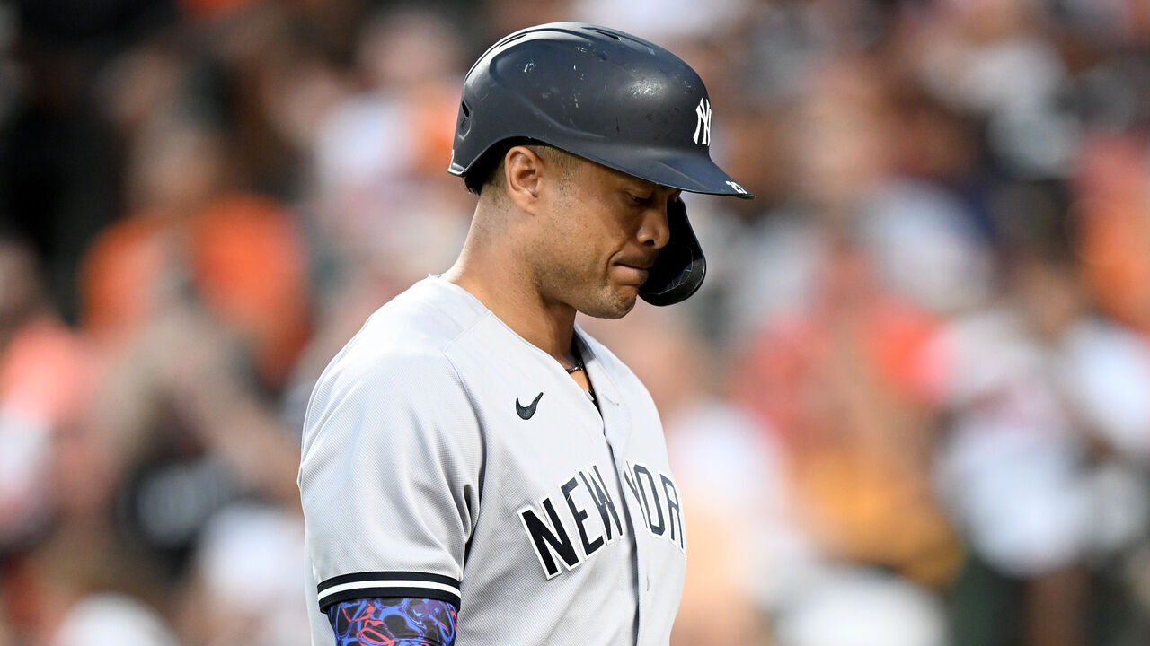 BALTIMORE, MARYLAND - JULY 30: Giancarlo Stanton #27 of the New York Yankees walks to the dugout after striking out in the third inning against the Baltimore Orioles at Oriole Park at Camden Yards on July 30, 2023 in Baltimore, Maryland.