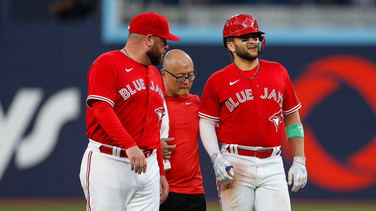 TORONTO, ON - JULY 31: Toronto Blue Jays shortstop Bo Bichette (11) is helped off the field by staff due to an injury in the third inning during a regular season game between the Baltimore Orioles and Toronto Blue Jays on July 31, 2023 at Rogers Centre in Toronto, ON.